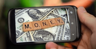 Picture on a cell phone of Scrabble letters on top of one dollar bills spelling out the word, MONEY.  These are indicating Money Pages, web pages that make you money.