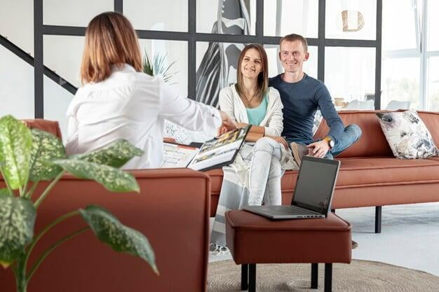 Female real estate agent with client couple